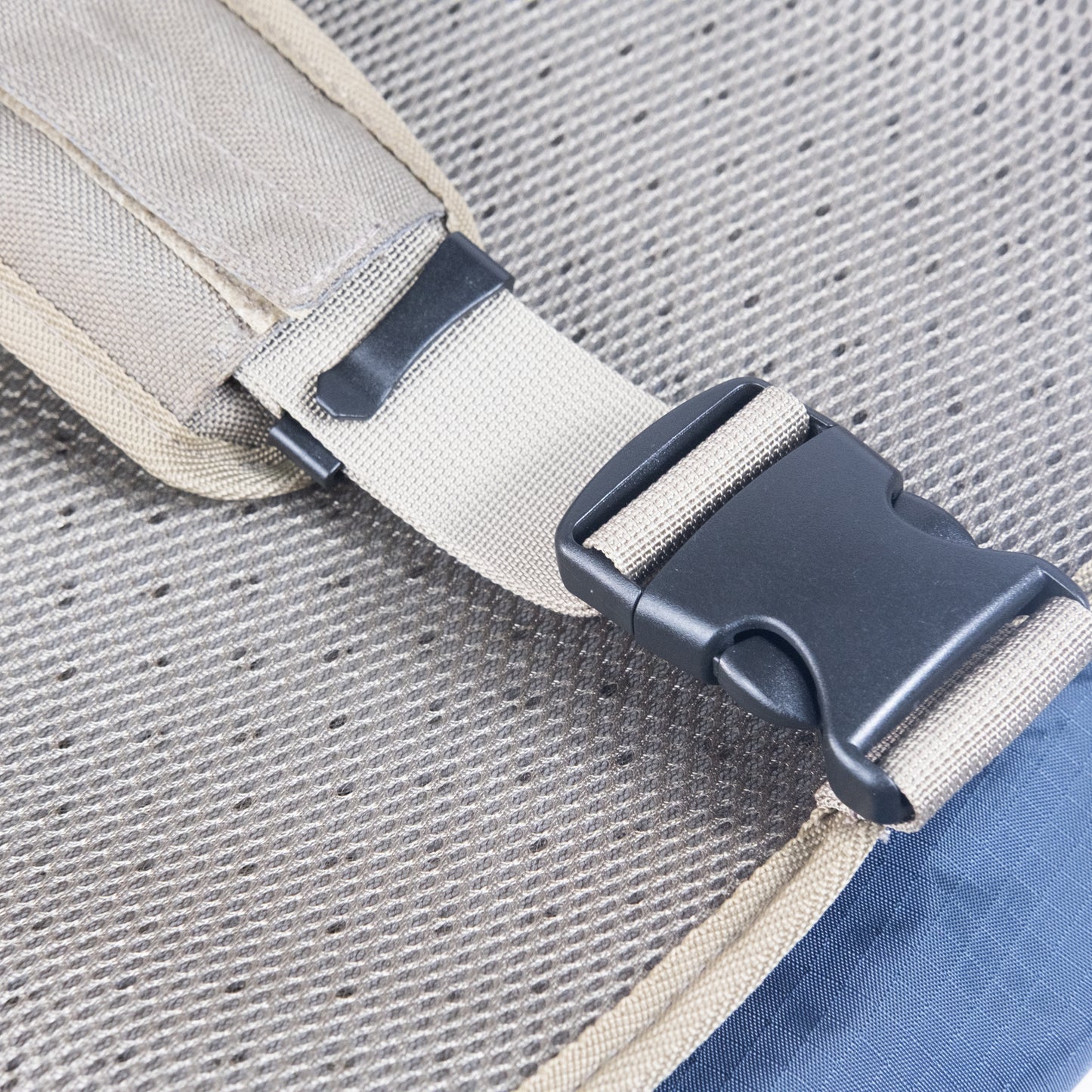 Waist strap buckle detail on adventure dog backpack for comfort and security