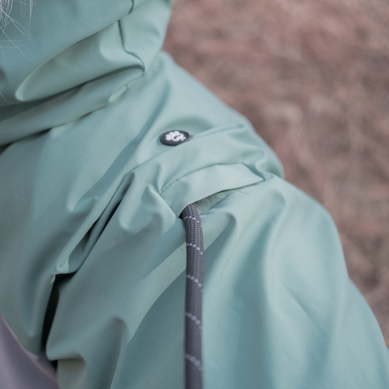 Dog raincoat showing back leash opening, designed for convenient leash attachment while keeping pets dry during outdoor adventures