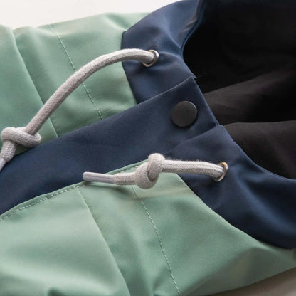 Dog raincoat hood with pull string, showcasing adjustable fit and protective waterproof design for outdoor adventures.