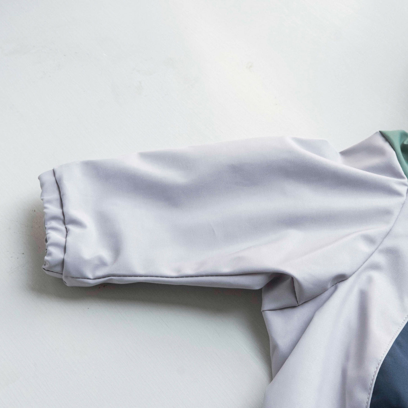 Close-up of dog raincoat sleeve, showing design, fit, and protection for outdoor adventures.